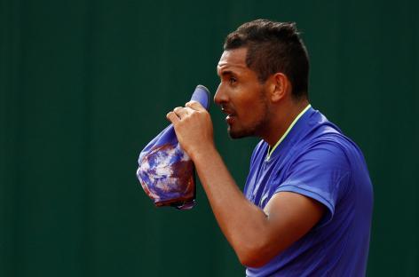 Nick Kyrgios returning a tennis ball.