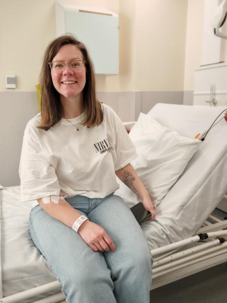 Woman sitting on a hospital bed.