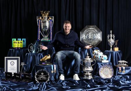 Jamie Vardy sitting among his trophies.