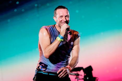 Chris Martin of Coldplay performing on stage.