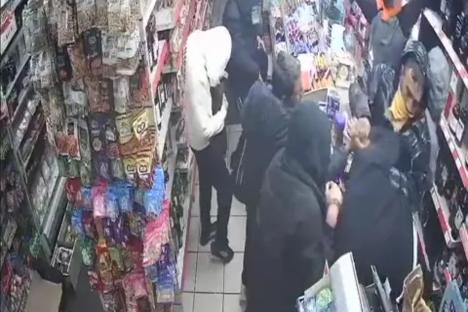 Shock footage shows eight hooded thugs raid family corner shop which refused to buy their stolen goods