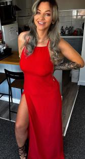 Woman in red dress in her kitchen.