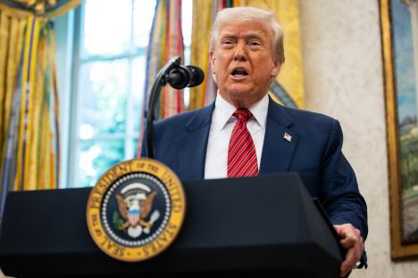 President Trump speaking at a podium in the Oval Office.