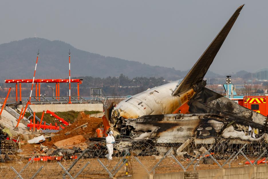 The damaged localizer antenna facility and wreckage of Jeju Air Flight 7C2216 at Muan International Airport.