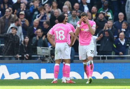 Two Southampton soccer players react after conceding a goal.