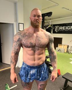 Hafþór JúlÃus Björnsson shirtless in gym, showing off his tattoos and physique.