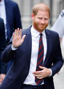 Prince Harry waving at a court hearing.