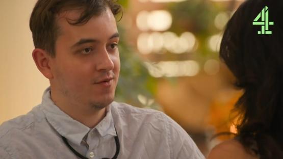 A man speaking to a woman, Channel 4 logo in corner.