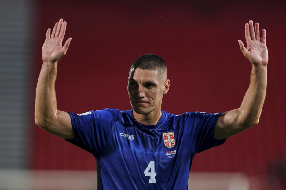 Referee showing a red card to a Serbian soccer player.