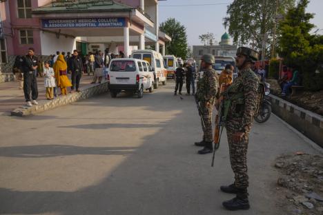 Indian security officers standing guard outside a hospital.