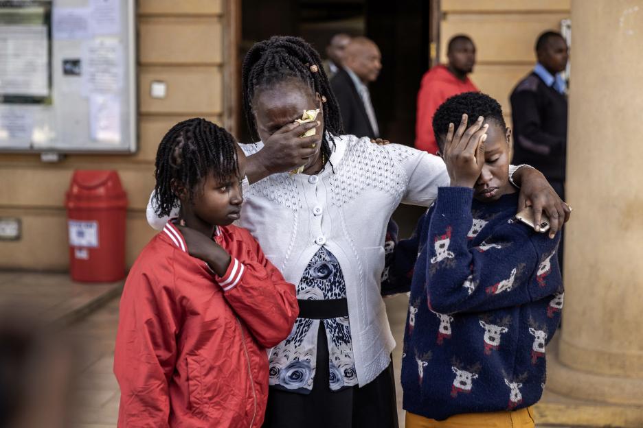 Agnes Wanjiru's daughter Stacy Wanjiru (left), sister Rose Wanyua (center), and niece Esther Njoki (right) hug after a court hearing.