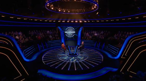 Who Wants to Be a Millionaire? set with contestant and host.