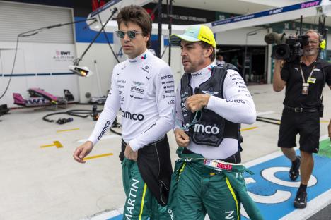 Fernando Alonso and Lance Stroll walking to the grid before a Formula 1 race.