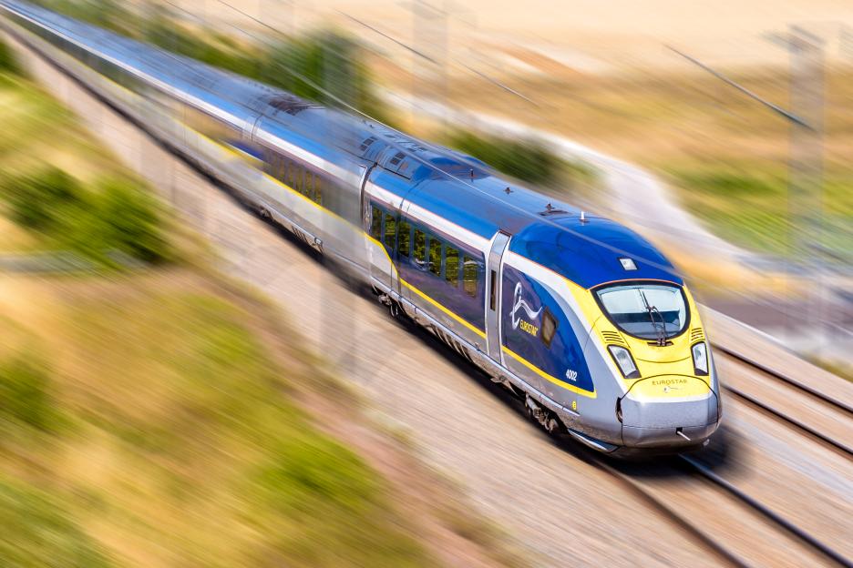 High-speed Eurostar train traveling through French countryside.