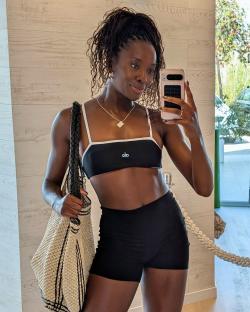 Woman taking a selfie in athletic wear.