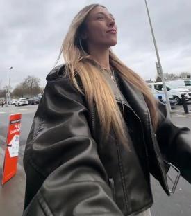 Woman in a leather jacket talking about a B&M bathroom purchase.