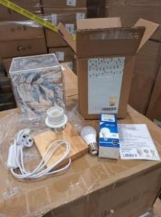 Recalled bedside table lamp with leaf print shade and packaging.