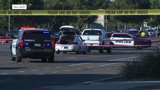 Crime scene with police cars and tape.