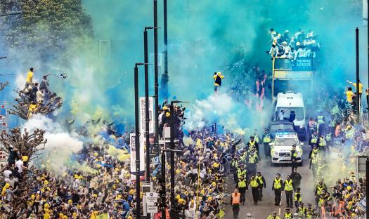 Leeds United championship parade with fans lining the streets.
