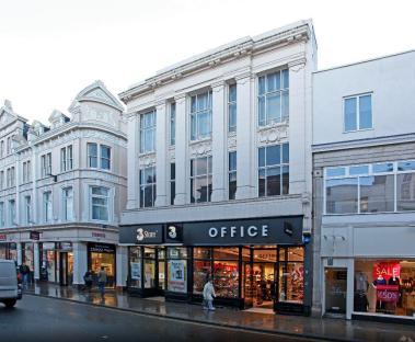 Street view of 27-28 George St, Richmond, showing an Office store and other shops.