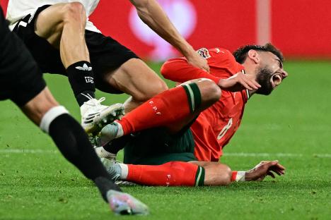 Bruno Fernandes reacts after being fouled during a soccer match.