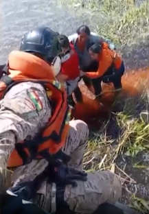 Rescuers pulling people from the water.