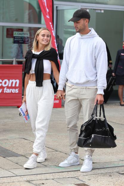 Millie Court and Liam Reardon arriving at an airport after winning Love Island.