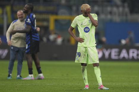 Lamine Yamal of Barcelona looking dejected on the soccer field.