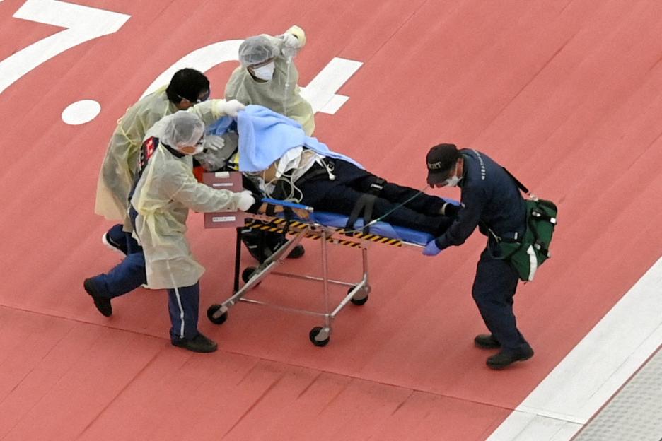 Former Japanese Prime Minister Shinzo Abe is carried on a stretcher by emergency responders.