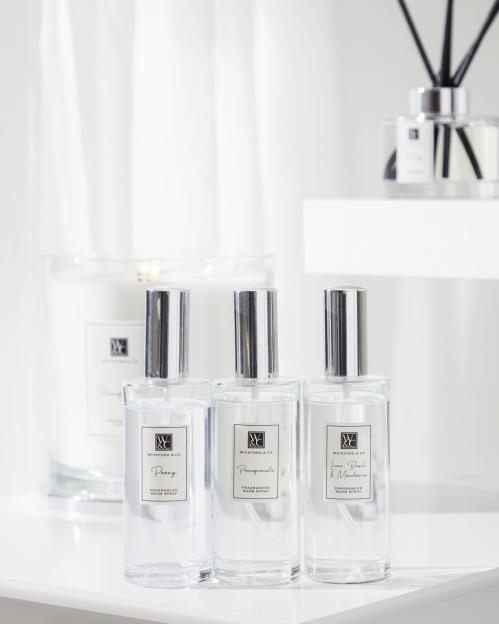 Three bottles of Wickford & Co. fragranced room spray in Peony, Pomegranate, and Lime, Basil & Mandarin scents.