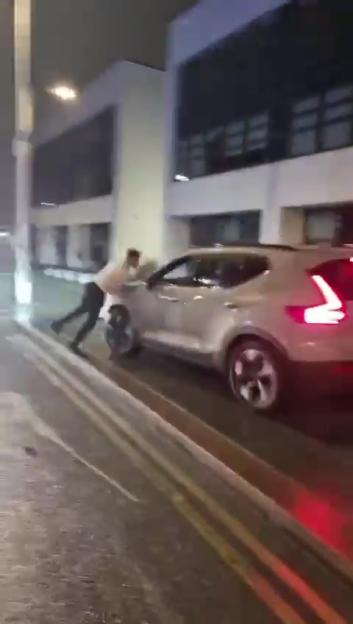 Shocking moment man is kicked as he lies on ground – before attacker is hit by a CAR
