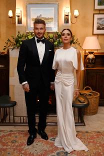 David and Victoria Beckham posing together at a dinner.