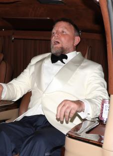 Guy Ritchie and his wife leaving a party.