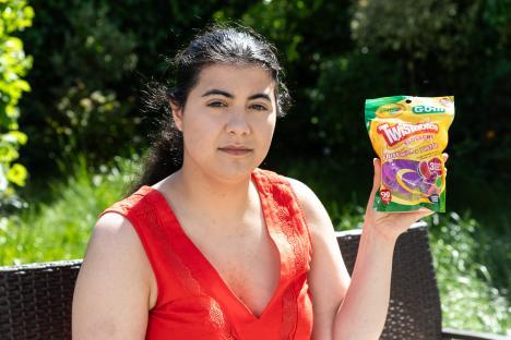 Woman holding a package of Crayola G.O.M. Twistables flossers.
