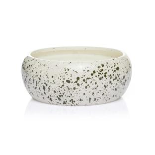 Citronella candle in a speckled ceramic jar.