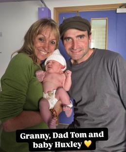 Granny, Dad Tom, and baby Huxley.