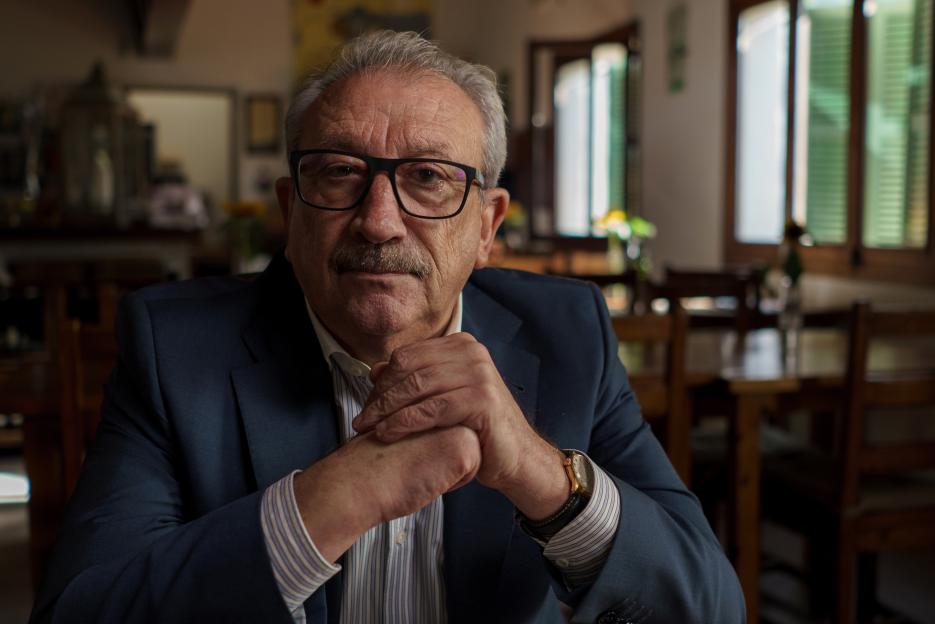 Portrait of an older man in a suit.