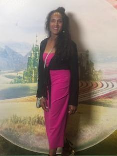 Portrait of a woman in a pink dress.