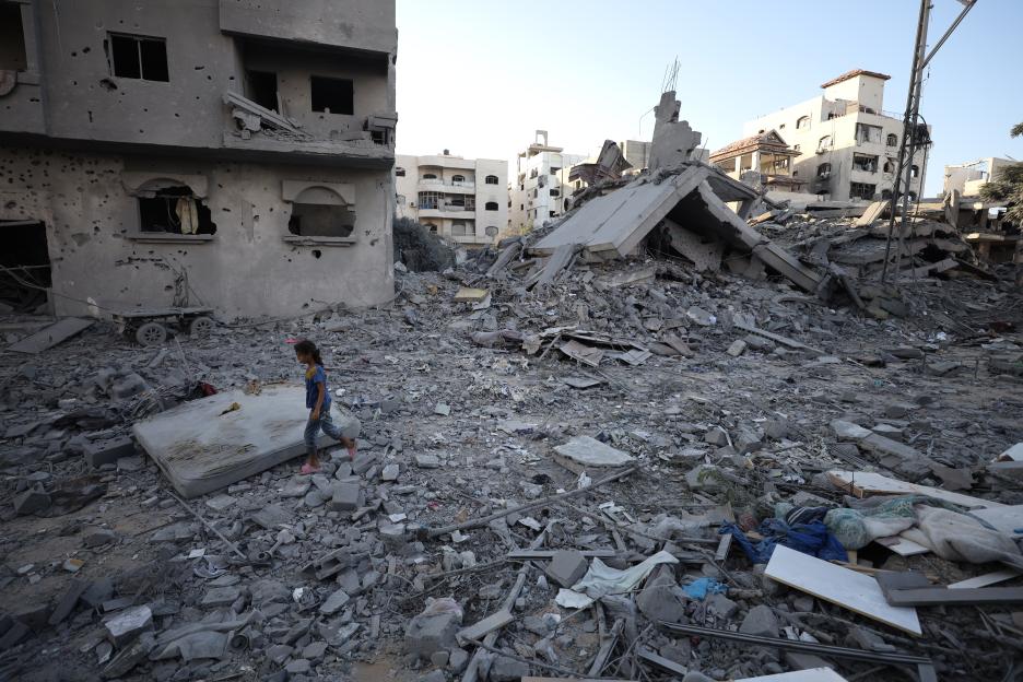 A child walks through the rubble of a destroyed building in Gaza City.