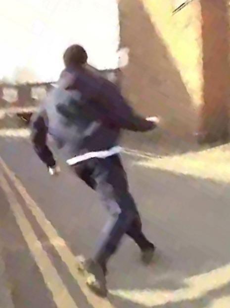 A man running away from police.