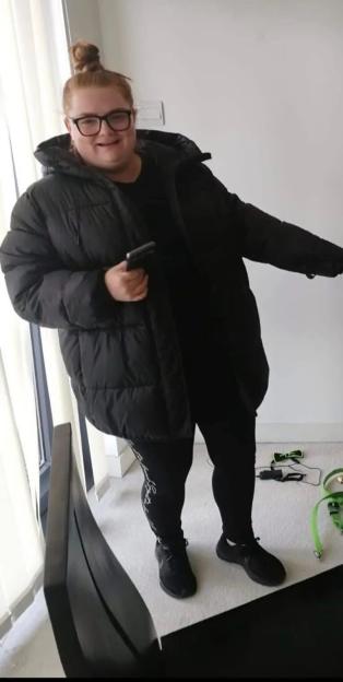 Woman in a black puffer jacket and leggings.