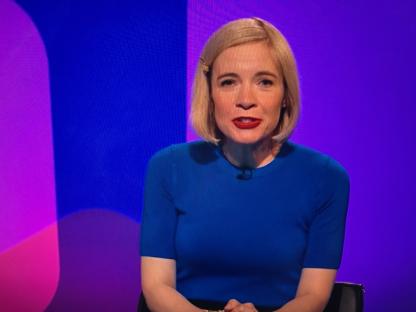 Woman in blue shirt on game show.