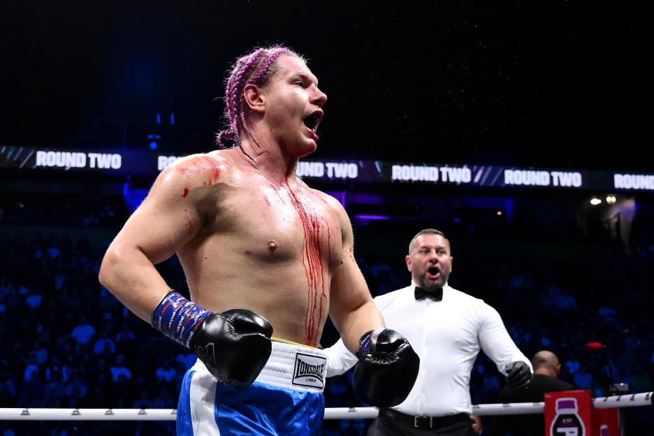 Bloody boxer reacting after a fight is stopped.