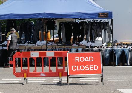 Road closed sign at a clothing market.