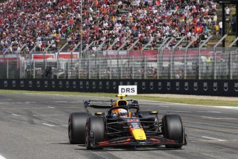 Yuki Tsunoda driving a Red Bull Formula One car on a racetrack.