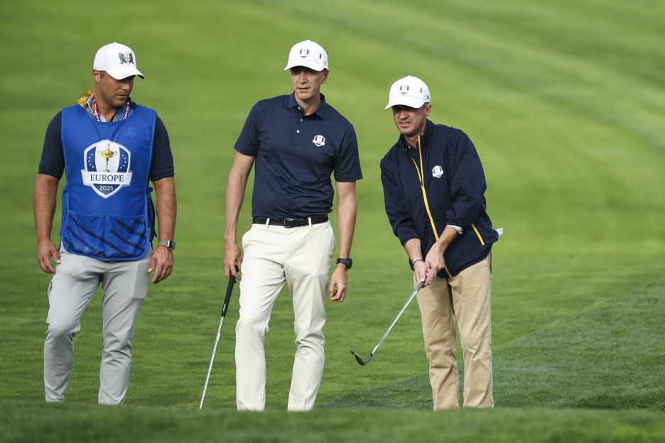Actors Oliver Phelps and Tom Felton at a golf course.