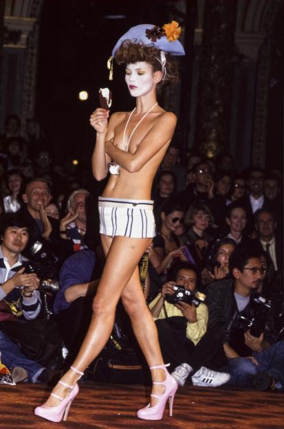 Kate Moss in a Vivienne Westwood fashion show, eating an ice cream bar.