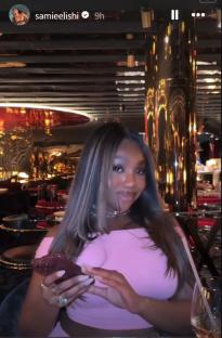 Whitney Adebayo on a night out, looking at her phone.