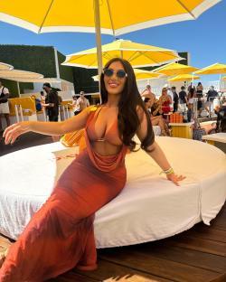Woman in orange dress at Ocean Beach Ibiza.