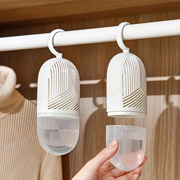 Two hanging dehumidifiers in a closet.